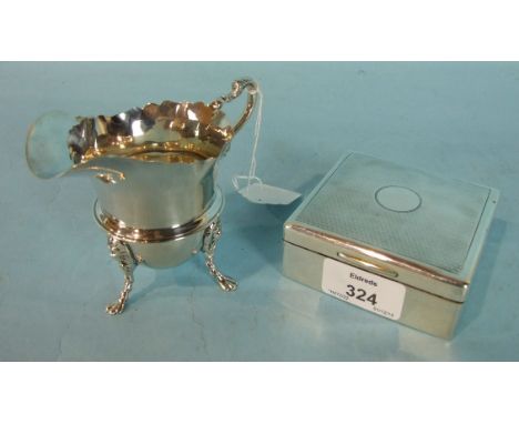 A helmet shaped cream jug, marks rubbed, and an engine turned cigarette box, marked "Boodles & Dunthorne", 8.5cm square, Lond