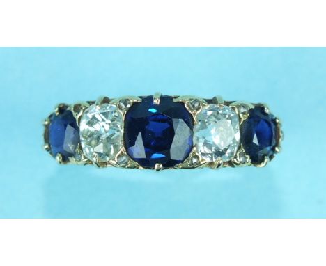 A Victorian sapphire and diamond ring claw set three round-cut sapphires and two old brilliant-cut diamonds, with diamond poi