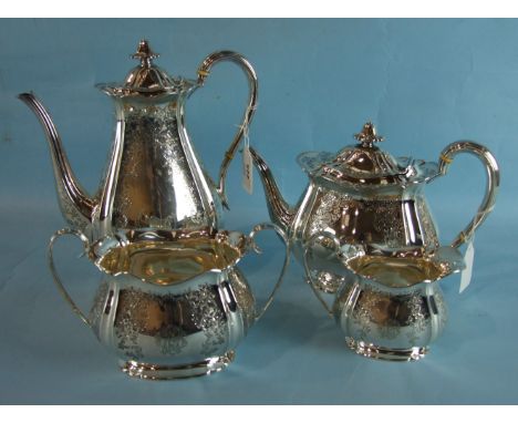 A Victorian four-piece tea service of tapered bombe shape, engraved with floral decoration and bearing presentation inscripti