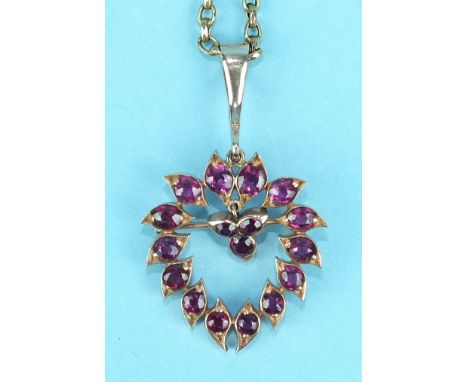 A ruby brooch/pendant of heart shape set fourteen round-cut rubies around a small drop set three rubies, in unmarked rose gol