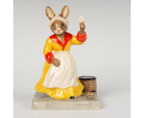 The spouse of a commander, at the dock waving goodbye as he sails away. Dressed in yellow, red, and white. Part of the Shipma