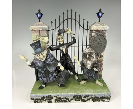 Disney Traditions created this porcelain figurine with ghosts at the gate to the Haunted Mansion. Lights at top of gates flic
