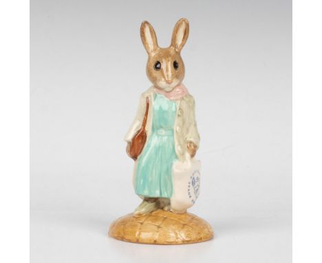 A bunny shopping for goods, wearing a green dress, beige coat, and carrying a branded tote. This item comes with its original