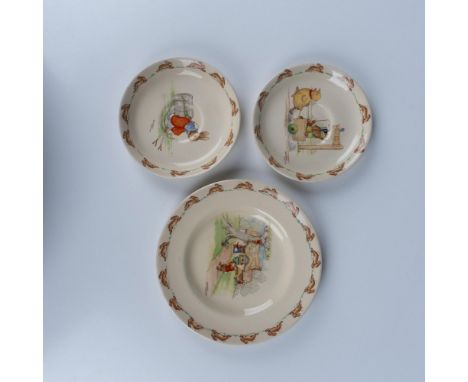A set of 3 cream colored Bunnykins plates featuring bunnies in various activities, including two kids taking a cart to the hu