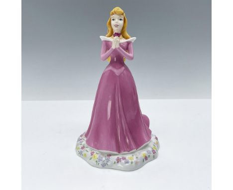 This hand-decorated glossy stoneware figurine depicts Sleeping Beauty in her pink ball gown and holding a rose in her delicat
