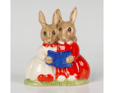 A figure of two bunnies with their arms around each other, while they read a book. White, red, and blue coloration. RDICC 15t