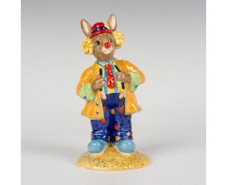 A figure of a performer dressed in colorful joyful clothing and adorned with a red nose. Celebrating 25 years of the RDIC Clu