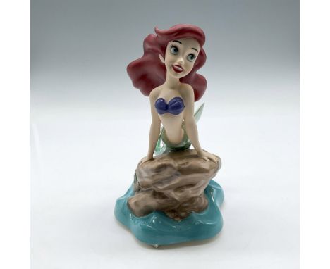 Ariel, Little Mermaid, sitting atop a rock with the waves below. Colored in emerald green, blue and red. Walt Disney Collecti
