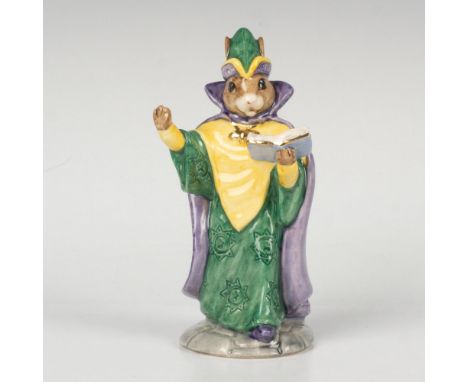 A spiritual figure dressed in a green and yellow outfit with a purple cape, holding a book and his arm up. This item comes wi