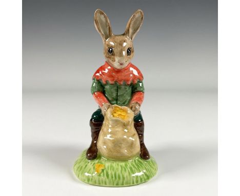 A fictional character from the classic folklore, dressed in a red and green hooded tunic and dark green pants with brown boot