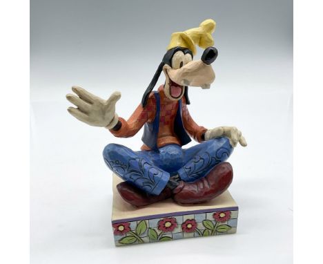 Disney Traditions figure sitting on flower platform with legs crossed in discussion. Colored in yellow, orange, blue and burg