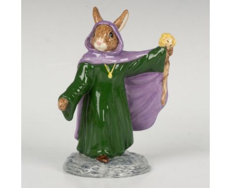 A figure of the legendary wizard, wearing a green dress, purple robe, and is holding up his wooden staff. Part of the Arthuri