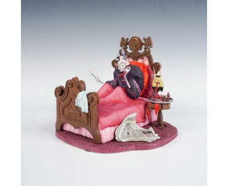 A porcelain figure of Cruella De Vil from 101 Dalmatians, in bed while talking on the phone. Part of the Villains series. WDC
