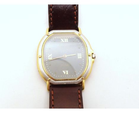 AN 18CT GOLD EBEL QUARTZ&nbsp; With bi colour gold case, grey dial with gold dot and Roman numerals, with a size 16 Hirsch Os