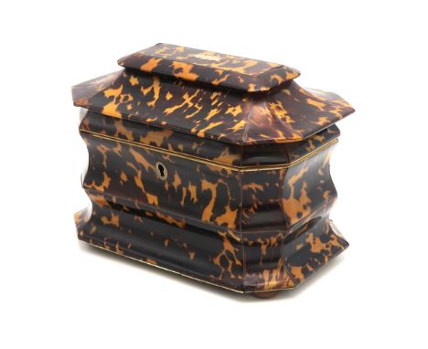 A VICTORIAN TORTOISESHELL TEA CADDY OF BOMBE CASKET FORM With ivory-banded twin-compartmentalised interior, raised on bun fee