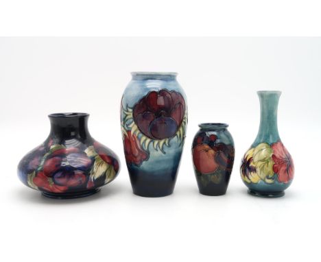 A COLLECTION OF MOORCROFT POTTERY including a squat Pansy vase on dark blue ground, 12cm high, a Anemone pattern vase, a Hibi