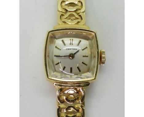 AN 18CT GOLD CERTINA WATCH with a white dial with gold coloured baton numerals and black baton hands. A ladies model sold in 