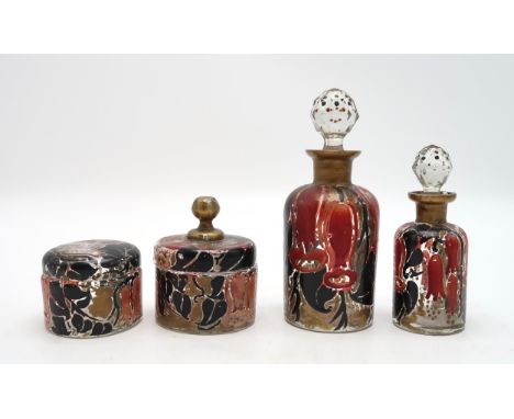 A SET OF FOUR ART DECO FRENCH GLASS TOILET JARS AND BOTTLES painted in red and black enamel with gilt, depicting large bell f