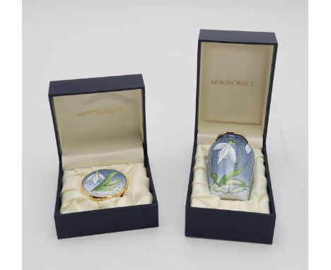 A MOORCROFT ENAMEL SNOWDROP TRINKET / PILL BOX 4.5cm diameter, together with a matching enamel vase, 7cm high, both with prin