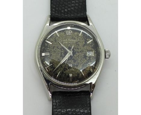 A VINTAGE GIRARD PERREGAUX the stainless steel gents Gyromatic watch, has a patinaed dial, silver coloured baton numerals and