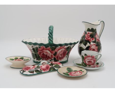 A COLLECTION OF WEMYSS CABBAGE ROSE PAINTED  POTTERY including a basket with twisted handle, 29cm long, a small ewer, 22cm hi