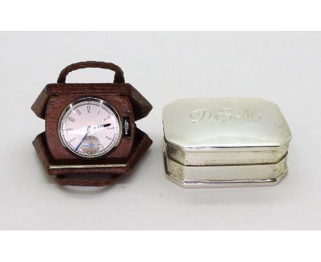 A NOVELTY WATCH AND A SILVER PILL BOX the watch in a leather handbag shaped case flips open to reveal a watch. the dial stamp