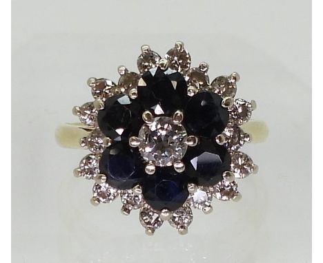 A SAPPHIRE & DIAMOND CLUSTER RING mounted in 18ct yellow gold the classic flower formation is set with estimated approx 0.42c