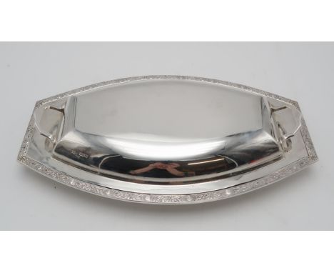 A GEORGE VI SILVER TUREEN AND COVER by S.G. Jacobs, Sheffield 1937, of shaped oval form, with celtic knotwork border featurin