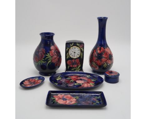 A COLLECTION OF MOORCROFT ANEMONE PATTERN PIECES including a bottle vase, 27cm high, a baluster vase, 19cm high, three trinke