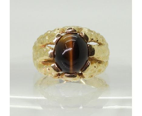 A GENTS RETRO TIGERS EYE RING made in bright yellow metal, the domed star burst ring is set with a&nbsp; 1mm x 9mm tigers eye