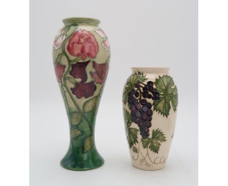 TWO MOORCROFT COLLECTORS CLUB PIECES including a Sweet Pea vase, 27.5cm high together with a Grapevine vase, 19cm high, both 