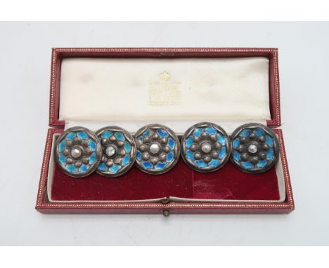 LIBERTY& CO; A set of five Cymric silver & enamel buttons, Birmingham 1901, decorated turquoise enamel petals surrounding a c