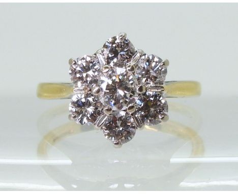 AN 18CT GOLD DIAMOND FLOWER RING  set with estimated approx 1.30cts of brilliant cut diamonds, finger size M, weight 4.3gms C