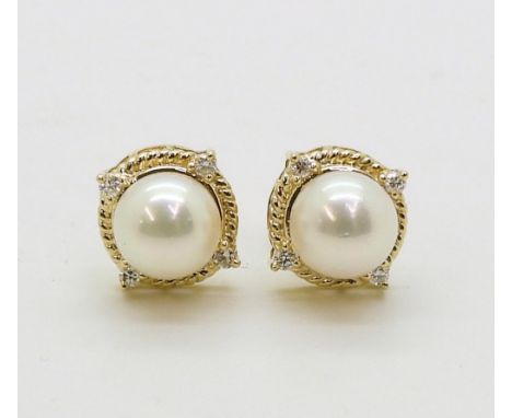 PEARL &amp; DIAMOND EARRINGS made in 18ct gold set with a pearl each approx 7.1mm, with the rope border set with four diamond