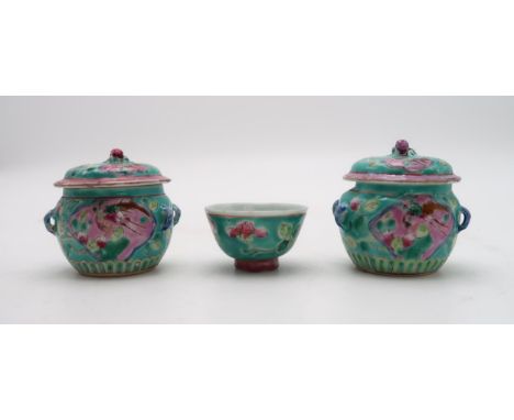 TWO CHINESE MINIATURE JARS AND COVERS&nbsp; each painted with birds and flowers,with peach finials, 6.5cm high and a similar 