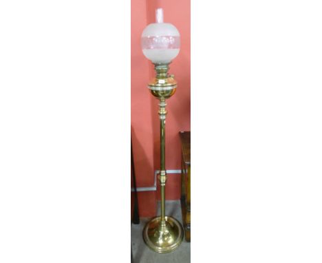 A brass oil lamp style standard lamp