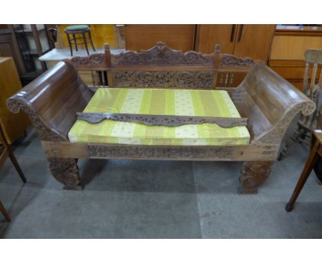 A Balinese hardwood bench sofa