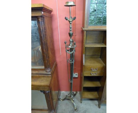 A brass tripod standard lamp