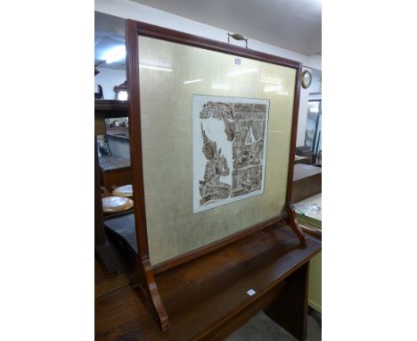 A mahogany firescreen with a print of a deity