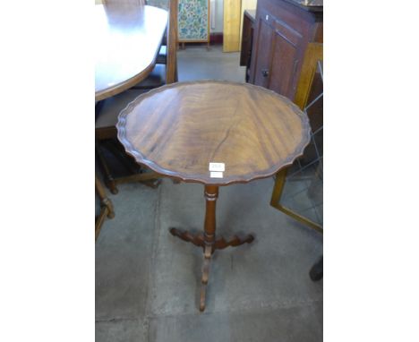 A mahogany tripod lamp table