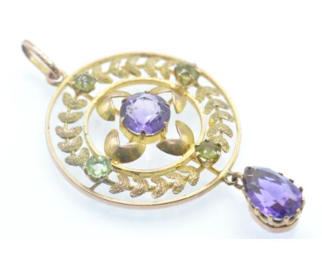 An early 20th century amethyst necklace pendant. The pendant strung with an amethyst drop, surmounted by an openwork wreath d