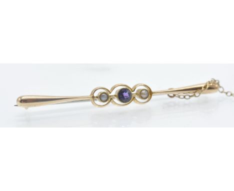 An antique 15ct gold amethyst and pearl bar brooch pin. The brooch se with a round mixed cu amethyst flanked by two half pear