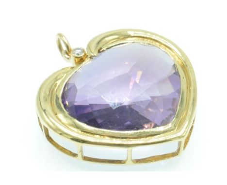 A hallmarked 18ct gold amethyst and diamond pendant. The pendant shaped in the form of a heart set with a large faceted heart