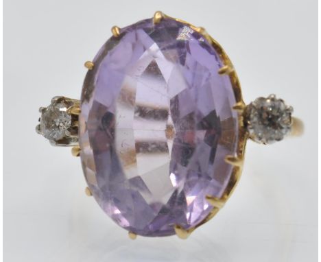 A French 18ct gold amethyst and diamond ring. The ring set with a large oval mixed cut amethyst, in a pierced prong setting, 