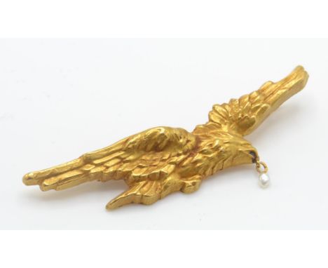 An Art Nouveau gold and pearl&nbsp; eagle bird brooch pin. The brooch in the form of an eagle in flight with seed pearl drop 