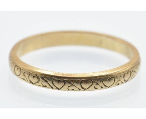 An 18ct gold heart band ring. The ring having repoussé heart decoration. Unmarked tests indicate 18ct gold. Weight 1.9g. Size