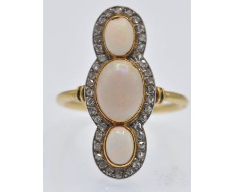 A French 18ct gold opal and diamond 'up finger' ring. The ring set with three oval opal cabochons framed by a border of rose 