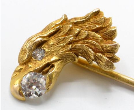 An 18ct gold and diamond figural eagle stick pin. The stick pin having an eagle head motif with diamond inset to beak and dia