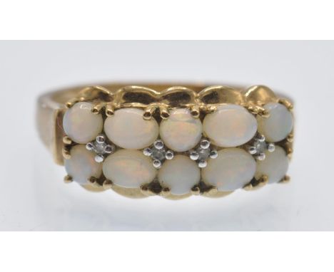 A hallmarked 9ct gold opal and diamond cluster ring.&nbsp; The ring set with two rows of round and oval opal cabochons with d