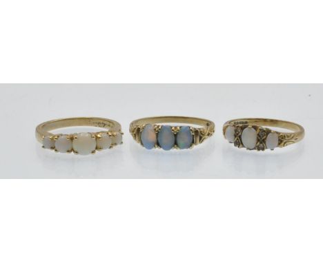 Three hallmarked 9ct gold and opal rings. To include; a three stone opal ring having diamond accents size M.5;&nbsp; A five s